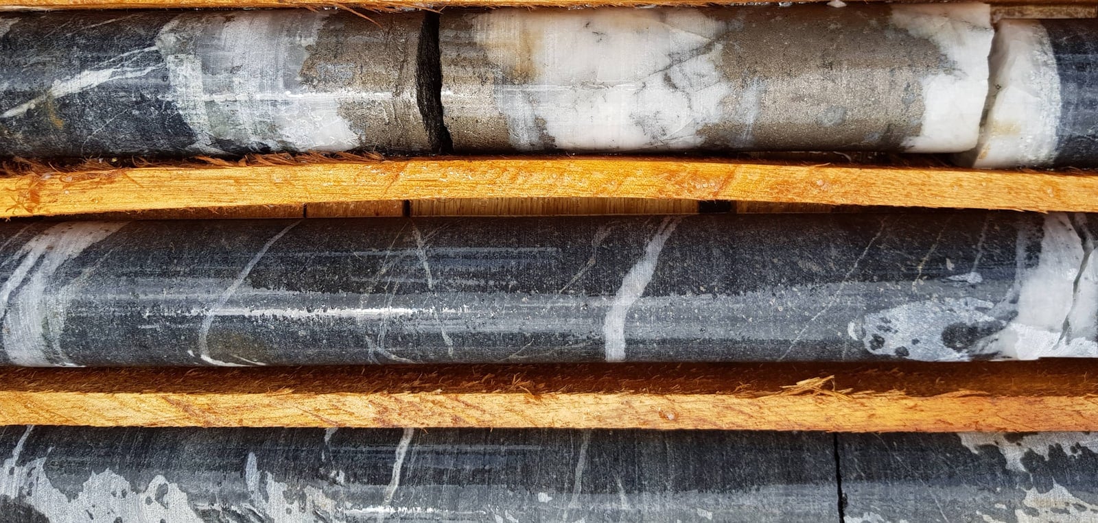 Drill core from the South Ridge zone at Kibi is displayed in a core tray.