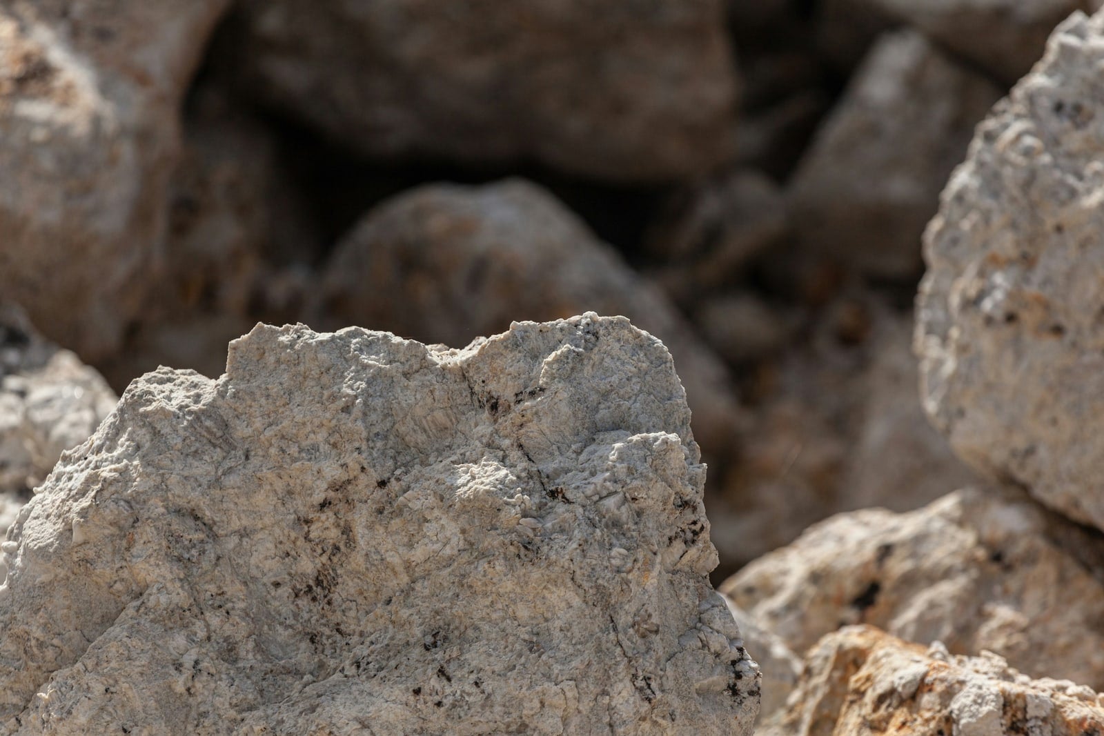 A close view of a rock formation with rocks in the background.