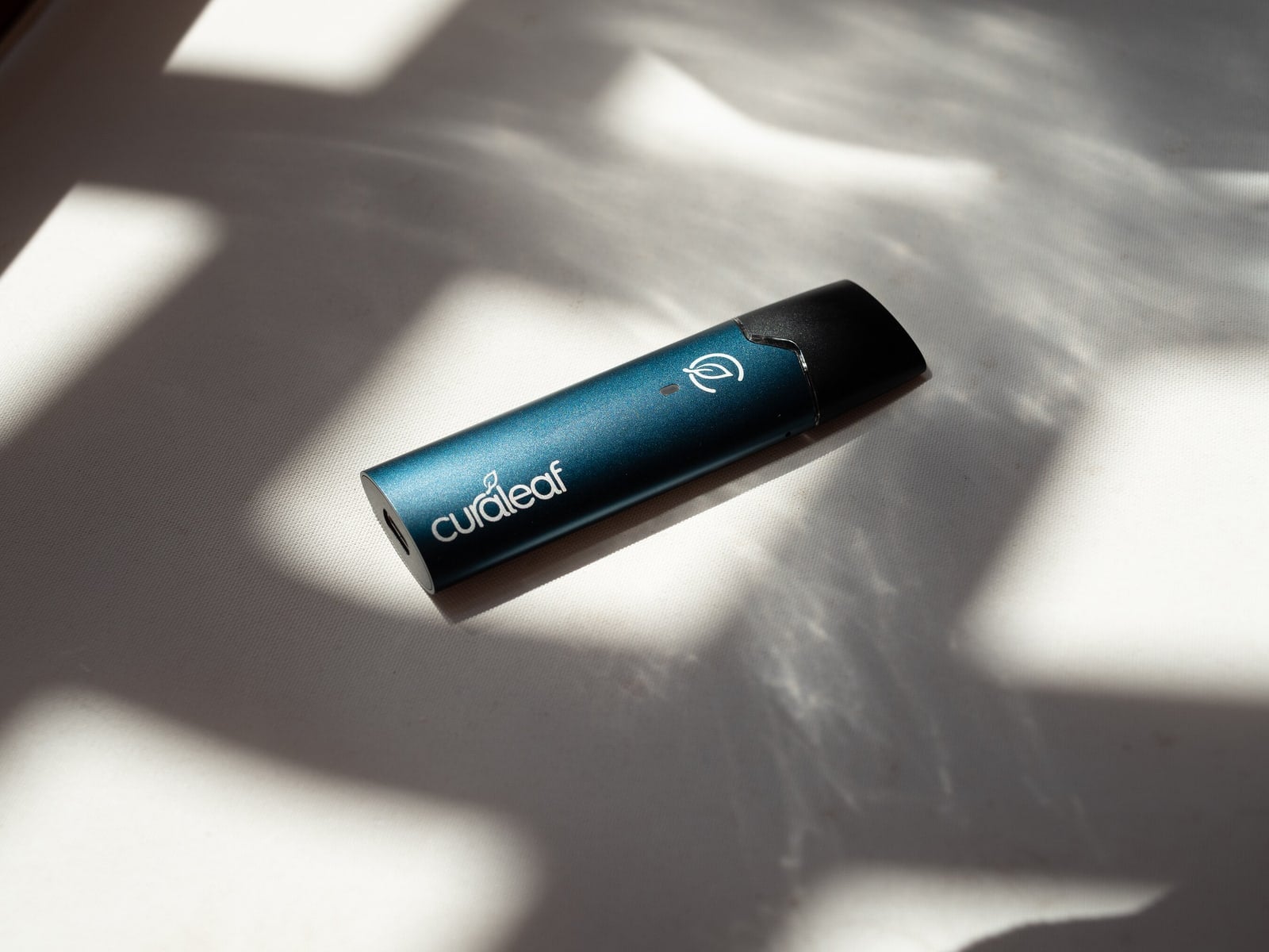 A company product photograph shows Curaleaf International's QMID inhalation device.