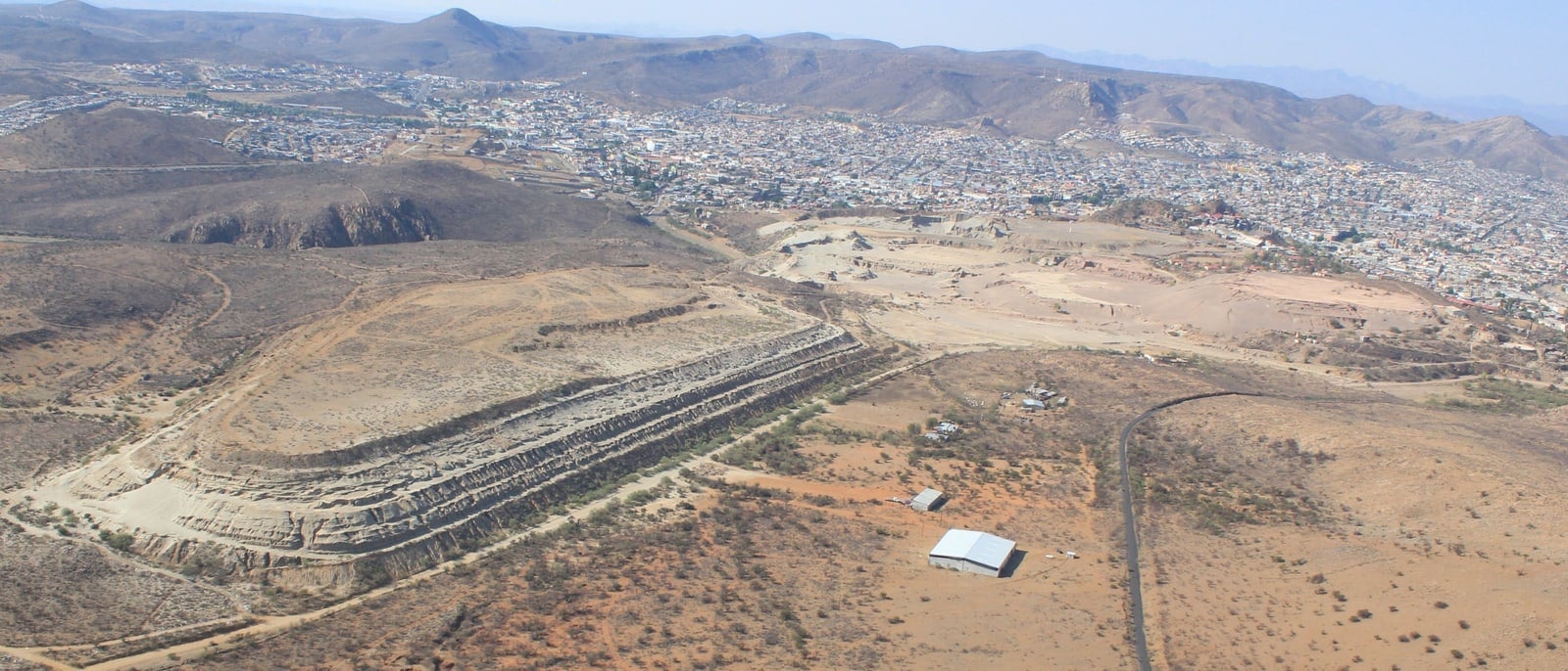 Historical tailings form a pale mound at Parral in Mexico.