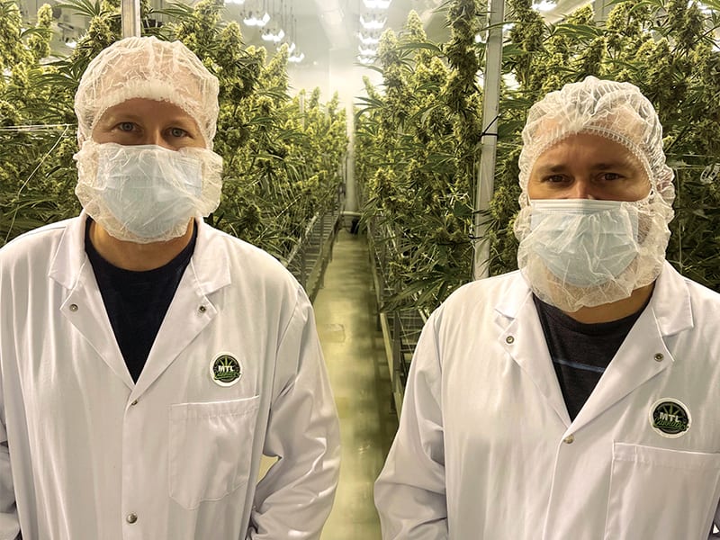 MTL Cannabis co-founders Rich and Mitch Clement standing in front of cannabis plants