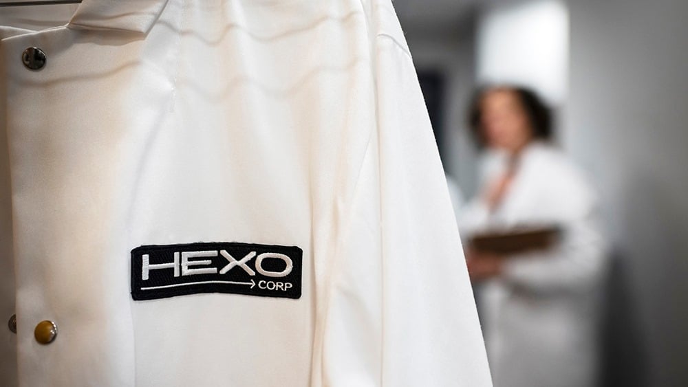 Close up of white lab coat showing HEXO Corp label