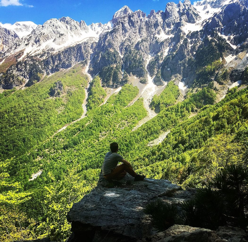 Nature amplifies therapeutic effects of psychedelics - study - person sitting rock mountains