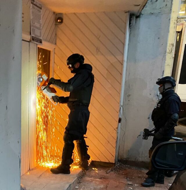 NCA officer breaking through reinforced door at grow op