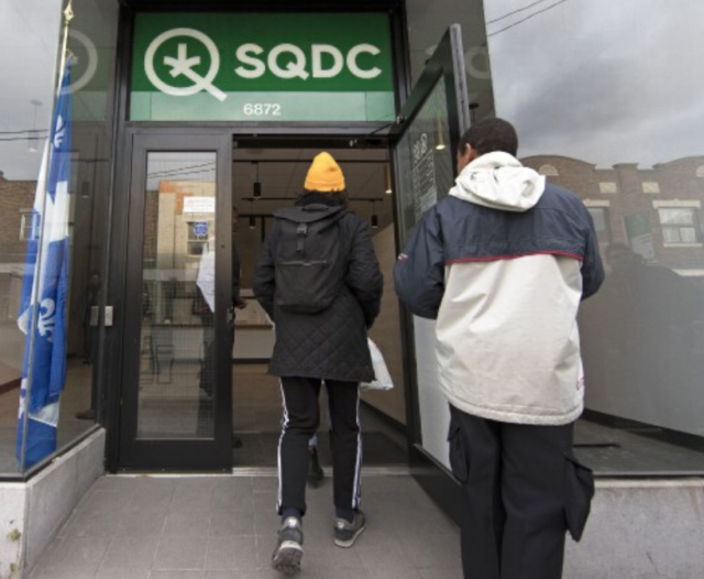 Two people entering SQDC store