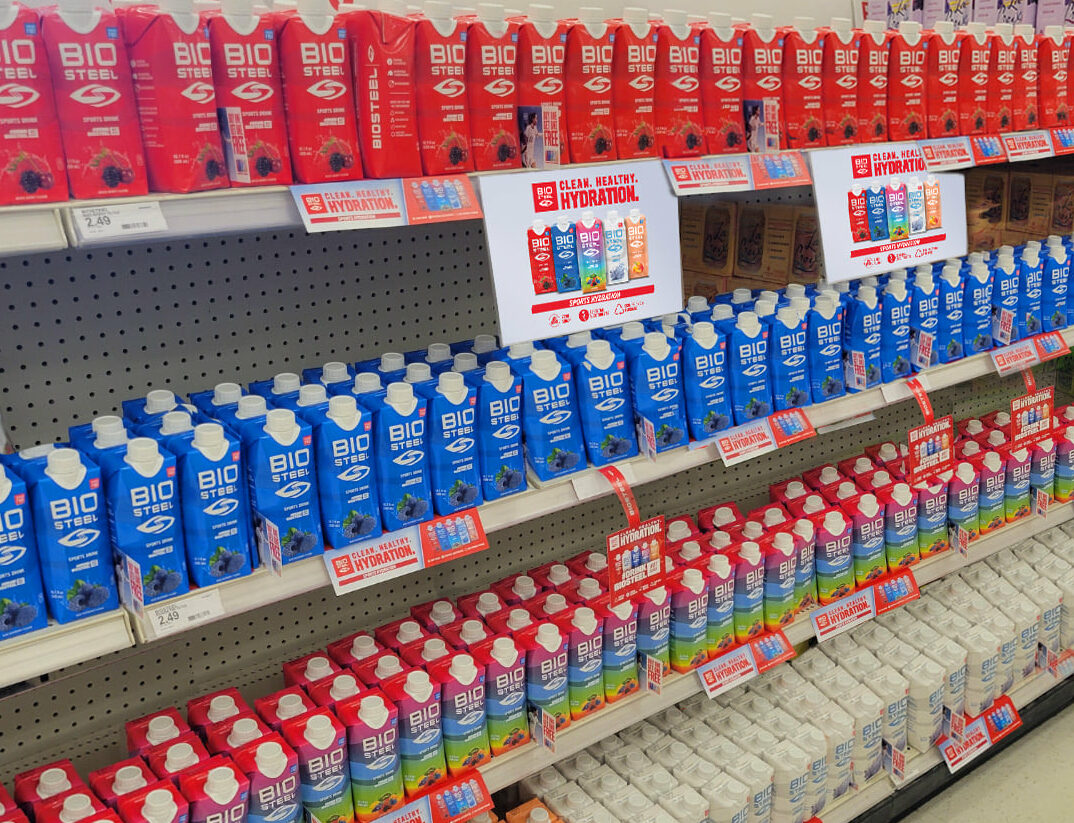 Four Shelves stocked with cartons of BioSteel